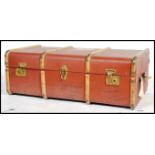 A vintage mid century wooden bound steamer trunk in brown having brass clasps to front.
