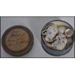 A 19th century Victorian miniature tea service in original circular box with notation to lid.