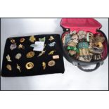 A case of vintage costume dress jewellery along with a group of 20 brooches to include