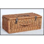 A vintage 20th century Fortnum and Mason wicker basket picnic hamper with stencilled lettering.