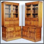 Ercol - Mural -  A pair of glazed window bookcases comprising of a twin glazed bookcase top with a