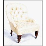 A 19th century Victorian mahogany button back nursing chair, recently upholstered raised on mahogany