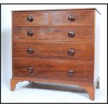 An early 19th century Georgian mahogany chest of drawers raised on bracket feet. The bank of two