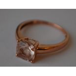 A hallmarked 9ct rose gold ring set with a cushion cut morganite.  Hallmarked Birmingham.  Size