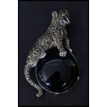 A sterling silver and marcasite brooch in the form of a leopard sat on an onyx moon. Pin to verso