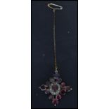 A 15ct gold Victorian garnet and seed pearl brooch having a central garnet with a halo of seed