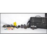 A vintage 20th century Minolta X - 500 35mm camera and accessories to include several lenses and a