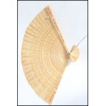 A 19th century Chinese ivory fan having 30 internal leaves / panels having pierced star and symbol