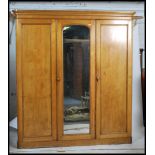 A 19th century Victorian ash / oak triple wardrobe linen press compactum. Raised on a plinth base