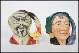 Two Royal Doulton large character jugs Genie D6892 and Fortune Teller D6497. Measures 17cm high.