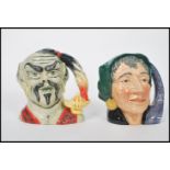 Two Royal Doulton large character jugs Genie D6892 and Fortune Teller D6497. Measures 17cm high.