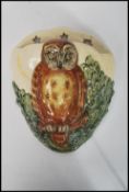 A Royal Doulton owl wall pocket / font depicting an owl in with a crescent moon having three stars