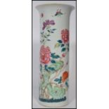 A 19th century Chinese famille rose vase. The tall cylindrical vase hand painted with floral