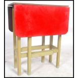 A vintage mid century red Formica topped oak kitchen drop leaf table having a gate leg action, of