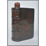 An unusual Royal Doulton earthenware spirit flask, in the form of a leather book, entitled The