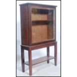 A Victorian oak display cabinet on stand. The stand having square tapered legs with lower tier.