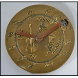 An unusual 20th century Rock Around The Clock calendar of circular form depicting musical