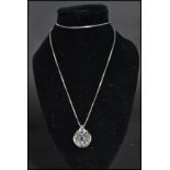 An 18ct white gold and sapphire pendant necklace of art deco form having a central blue sapphire