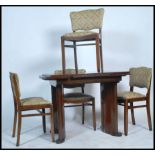 A 1930's Art Deco dark walnut draw leaf dining table together with a matching set of 4 dining