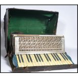 A vintage 20th century Carlos Carsini accordion musical instrument complete in original case.