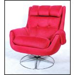 A 20th Century retro Danish inspired red upholstered swivel easy lounge chair, having tubular chrome