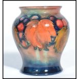 An early 20th century William Moorcroft for Moorcroft small squat vase hand painted and tube lined