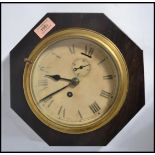 A vintage early 20th century bulkhead clock having a wooden back. The silvered dial having faceted