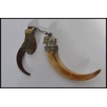 A late 19th early 20th century pendant formed from an eagle talon / claw together with another