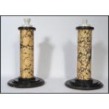 A pair of 20th century electric faux marble matching table lamps the faux marble columns raised on