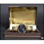 A vintage Longines quartz movement wrist watch complete in the original box. The black enamel face