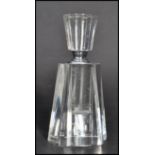 A vintage Art Deco faceted glass perfume bottle having a rounded octagonal body and stopper.