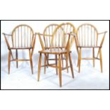 A set of four Ercol mid 20th century carver hoop back chairs having spindle backs with CC41