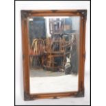 A large 20th century antique style bevelled edge overmantel mirror having a rectangular frame with