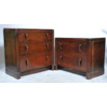 A matched pair of 1940's oak utility furniture chests of drawers having shaped handles together with