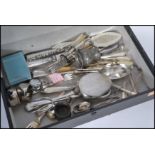 A collection of silver plated items including spoons , tongs , serving knives , napkin rings ,