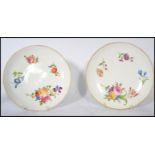 A pair of 19th century ceramic cabinet plates hand painted with floral sprays raised on a circular