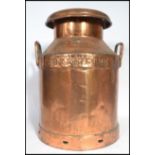 A vintage early 20th century copper dairy milk churn having handles to sides. With notation for