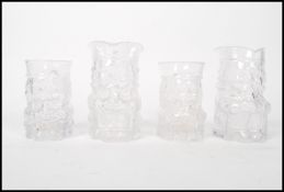 A group of four Whirefriars studio art clear pressed glass Toby Jugs in pairs of graduating sizes.