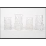 A group of four Whirefriars studio art clear pressed glass Toby Jugs in pairs of graduating sizes.