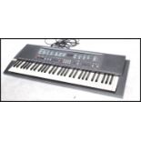 A 1990's Yamaha PSR200 electronic keyboard complete in the original box.