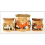 A group of three Doulton Lambeth seated Toby Jugs having impressed marks to base. 8588 5588 and