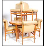A 20th century retro teak wood Danish inspired dining room suite of six chairs and matching
