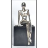 A vintage 20th century Art Deco chrome figurine of a lady raised on a ebonised wooden plinth base.