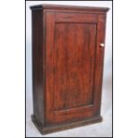 A 19th century Victorian pitch pine hall church cabinet having full length panel door enclosing