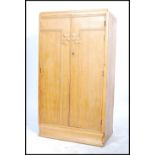 A vintage 20th century 1930's Art  Deco oak tall boy / bachelors wardrobe having carved geometric