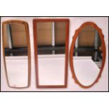 A group of three vintage 20th century retro teak mirrors. One being an frame less example.