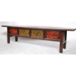 An early 20th century antique Chinese fir wood low four drawer alter table having handpainted floral