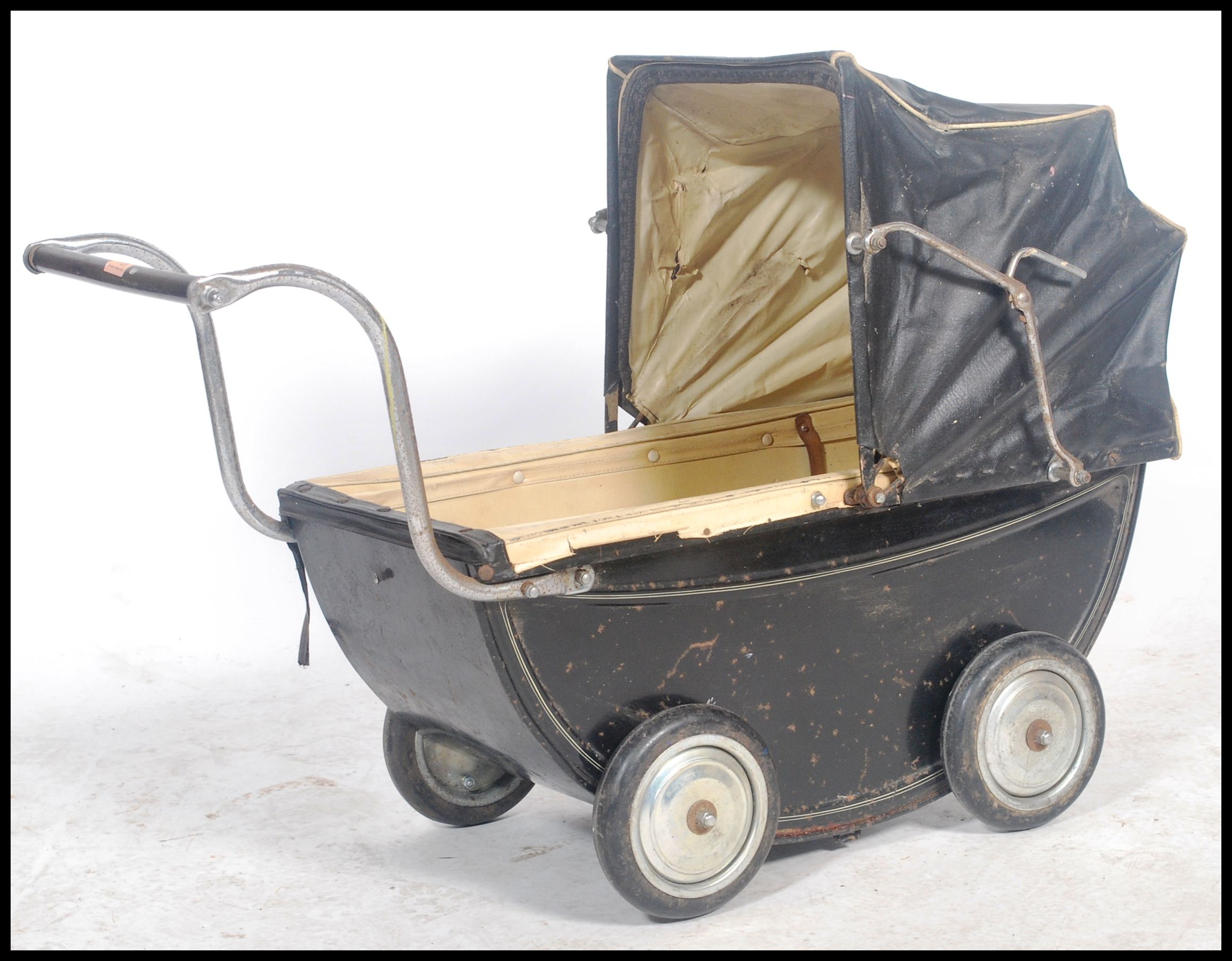 A vintage 20th century childs enamel painted pram in black with the original spoked wheels. The