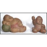 A pair of 20th century Asian carved and painted hardwood Buddhas, both of typical poses. Highest