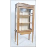 An Edwardian oak display cabinet having a lined interior with shelves, full length astragal glazed